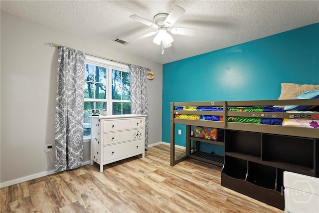 31 Pembroke Pl, Pembroke, GA 31321 - bedroom with wood finished floors, a textured ceiling, and a ceiling fan
