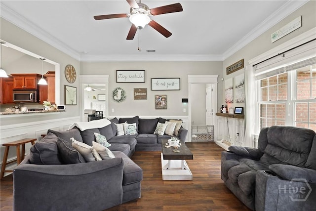 308 NE Mancey Garrason Loop, Ludowici, GA 31316 - living area featuring ceiling fan, crown molding, dark wood finished floors, and a wainscoted wall