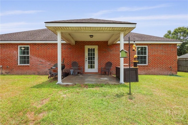 308 NE Mancey Garrason Loop, Ludowici, GA 31316 - back of property with a patio, brick siding, and a shingled roof