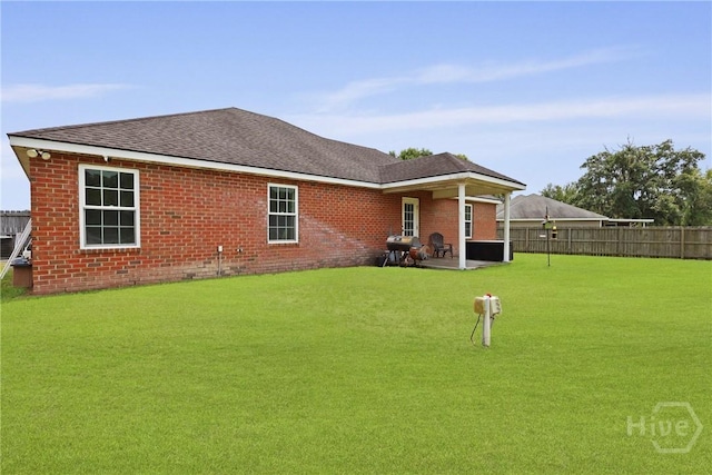 308 NE Mancey Garrason Loop, Ludowici, GA 31316 - back of property with a patio area, brick siding, and roof with shingles