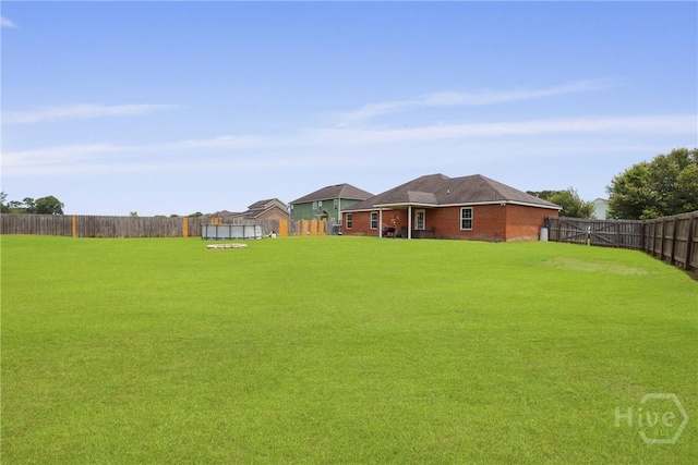 308 NE Mancey Garrason Loop, Ludowici, GA 31316 - fenced backyard with a trampoline