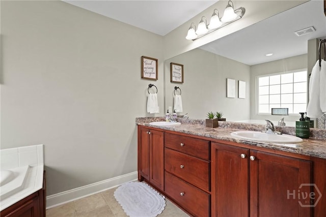 308 NE Mancey Garrason Loop, Ludowici, GA 31316 - bathroom featuring double vanity, a bathtub, and tile patterned flooring