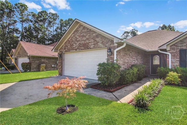 116 Gloucester Dr, Midway, GA 31320 - ranch-style home featuring brick siding, a front yard, a shingled roof, driveway, and an attached garage