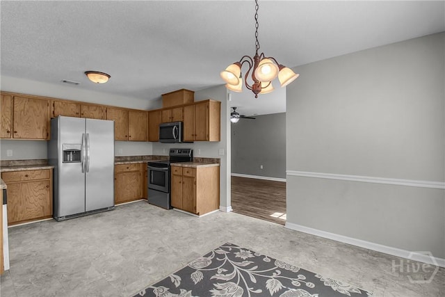 116 Gloucester Dr, Midway, GA 31320 - kitchen featuring stainless steel appliances, brown cabinets, decorative light fixtures, a chandelier, and a ceiling fan