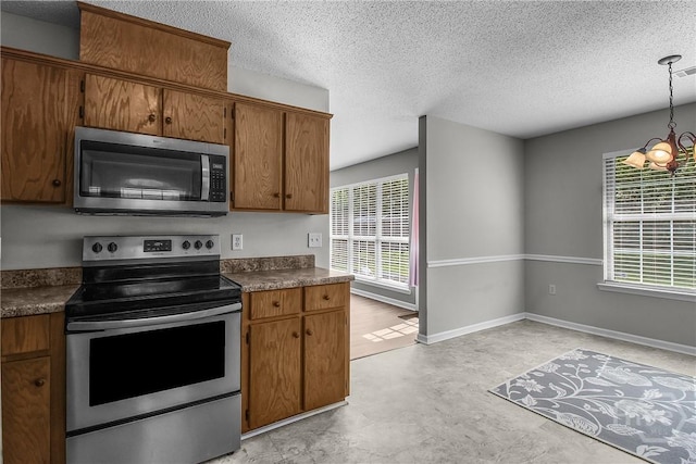 116 Gloucester Dr, Midway, GA 31320 - kitchen featuring stainless steel appliances, healthy amount of natural light, a chandelier, a textured ceiling, and dark countertops