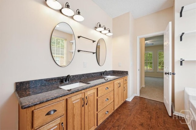 301 Marshview Dr, Richmond Hill, GA 31324 - bathroom with double vanity, a bathtub, and wood finished floors