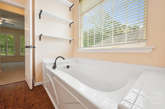 301 Marshview Dr, Richmond Hill, GA 31324 - full bathroom featuring a garden tub, ceiling fan, and wood finished floors