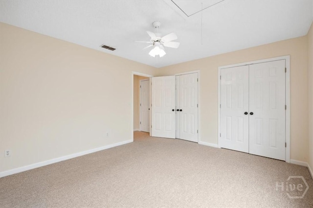 301 Marshview Dr, Richmond Hill, GA 31324 - unfurnished bedroom featuring two closets, light colored carpet, attic access, and a ceiling fan