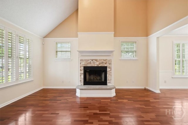 301 Marshview Dr, Richmond Hill, GA 31324 - unfurnished living room featuring high vaulted ceiling, wood finished floors, and a fireplace with raised hearth