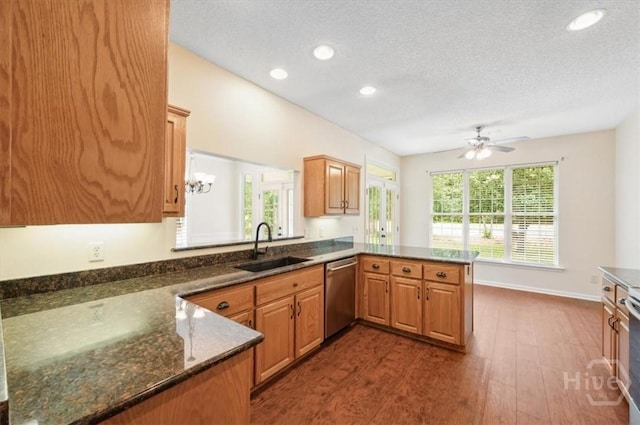 301 Marshview Dr, Richmond Hill, GA 31324 - kitchen with stainless steel dishwasher, a peninsula, dark wood-type flooring, recessed lighting, and ceiling fan