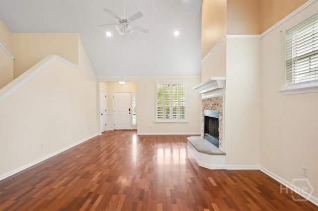 301 Marshview Dr, Richmond Hill, GA 31324 - unfurnished living room featuring high vaulted ceiling, a ceiling fan, a fireplace, and wood finished floors
