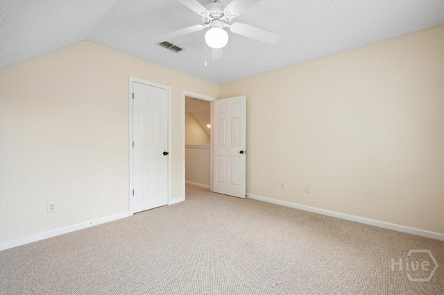 301 Marshview Dr, Richmond Hill, GA 31324 - unfurnished bedroom with light colored carpet, a textured ceiling, lofted ceiling, and a ceiling fan