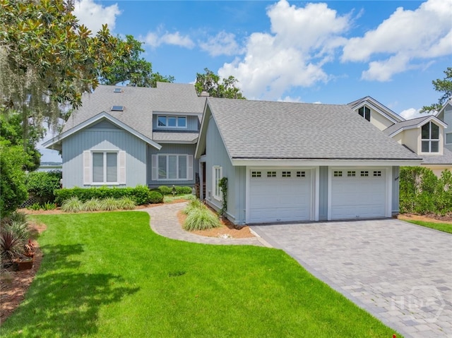 3 She Crab Cir, Savannah, GA 31411 - view of front of property with an attached garage, decorative driveway, roof with shingles, and a front lawn