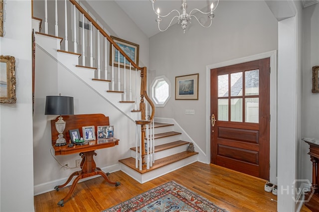 3 She Crab Cir, Savannah, GA 31411 - entrance foyer with stairway, wood finished floors, vaulted ceiling, and a chandelier
