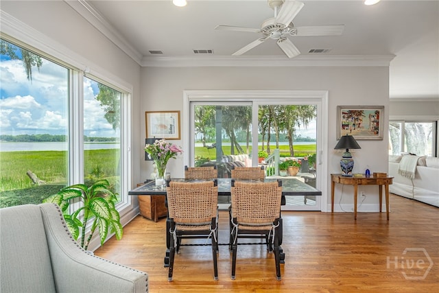 3 She Crab Cir, Savannah, GA 31411 - dining space with light wood-style floors, a ceiling fan, recessed lighting, crown molding, and a water view