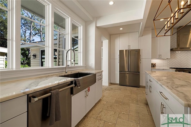 52-56 E Broad St, Savannah, GA 31401 - kitchen featuring appliances with stainless steel finishes, healthy amount of natural light, decorative backsplash, stone tile flooring, and recessed lighting