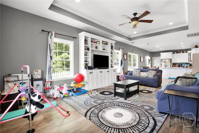 1416 Hillridge Dr, Darien, GA 31305 - living area with a tray ceiling, a ceiling fan, wood finished floors, recessed lighting, and crown molding