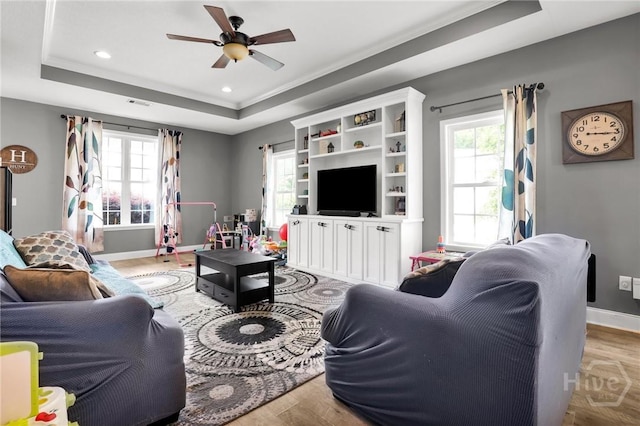 1416 Hillridge Dr, Darien, GA 31305 - living room with a tray ceiling, wood finished floors, ceiling fan, and recessed lighting