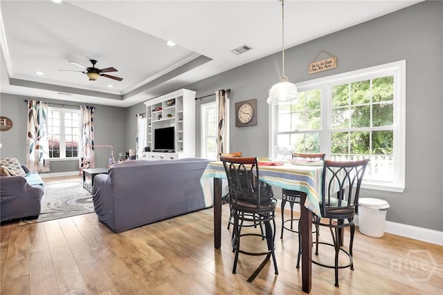1416 Hillridge Dr, Darien, GA 31305 - dining area featuring a raised ceiling, ceiling fan, light wood-style flooring, and recessed lighting