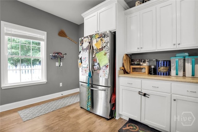 1416 Hillridge Dr, Darien, GA 31305 - kitchen featuring freestanding refrigerator, light wood-type flooring, white cabinets, and light countertops