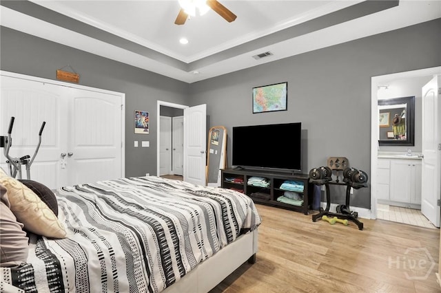 1416 Hillridge Dr, Darien, GA 31305 - bedroom with a raised ceiling, light wood-style floors, recessed lighting, a closet, and ensuite bathroom