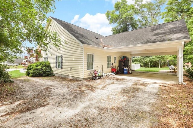 1416 Hillridge Dr, Darien, GA 31305 - view of side of property featuring driveway, an attached carport, and a shingled roof