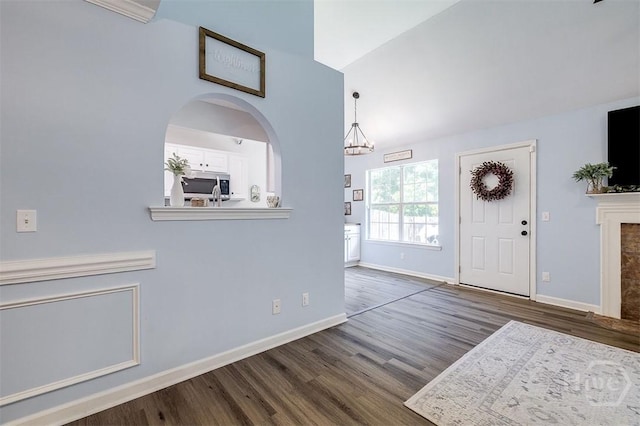 26 Dianne Mackenzie Way, Savannah, GA 31419 - foyer with wood finished floors, a chandelier, a fireplace, and vaulted ceiling