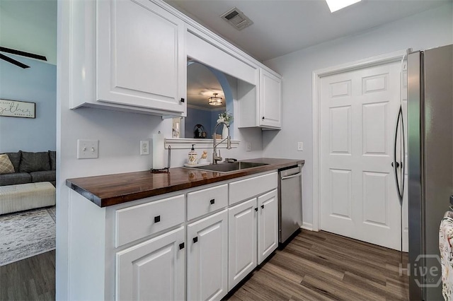 26 Dianne Mackenzie Way, Savannah, GA 31419 - kitchen with stainless steel appliances, butcher block countertops, dark wood finished floors, and white cabinets