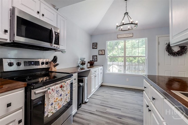 26 Dianne Mackenzie Way, Savannah, GA 31419 - kitchen featuring appliances with stainless steel finishes, wood counters, a chandelier, white cabinetry, and lofted ceiling