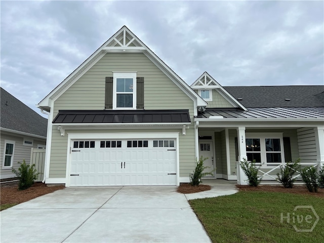 660 Blue Moon Xing, Pooler, GA 31322 - view of front of home with a standing seam roof, concrete driveway, a garage, and a metal roof