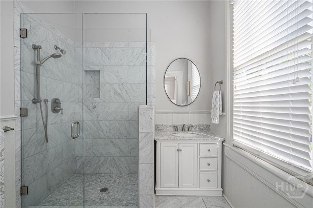 121 W Bolton St, Savannah, GA 31401 - bathroom with a shower stall, vanity, wainscoting, and marble look tiles