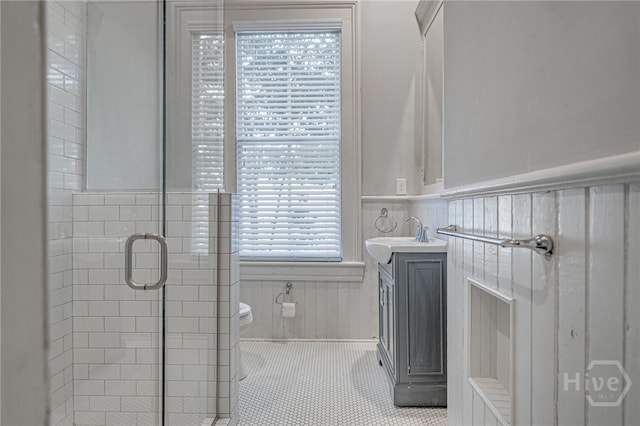 121 W Bolton St, Savannah, GA 31401 - bathroom with a wainscoted wall, vanity, a shower stall, and tile patterned floors