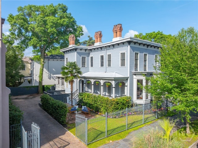 121 W Bolton St, Savannah, GA 31401 - italianate home featuring a fenced front yard, a chimney, and a gate