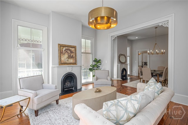 121 W Bolton St, Savannah, GA 31401 - living area featuring a fireplace with flush hearth, a chandelier, and wood finished floors