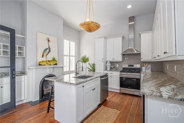 121 W Bolton St, Savannah, GA 31401 - kitchen with appliances with stainless steel finishes, wall chimney range hood, dark wood-style floors, backsplash, and recessed lighting