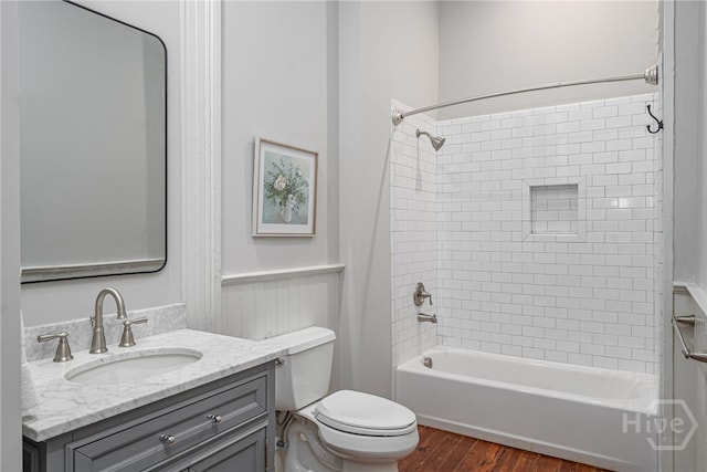 121 W Bolton St, Savannah, GA 31401 - bathroom featuring wood finished floors, vanity, bathtub / shower combination, and a wainscoted wall