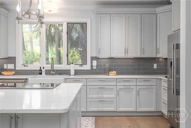 1 Broomsedge Ln, Savannah, GA 31411 - kitchen featuring high quality fridge, light countertops, ornamental molding, a chandelier, and backsplash