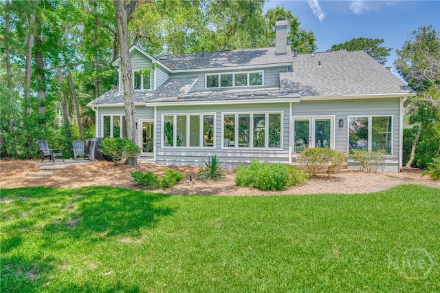 1 Broomsedge Ln, Savannah, GA 31411 - rear view of house with a lawn and a chimney