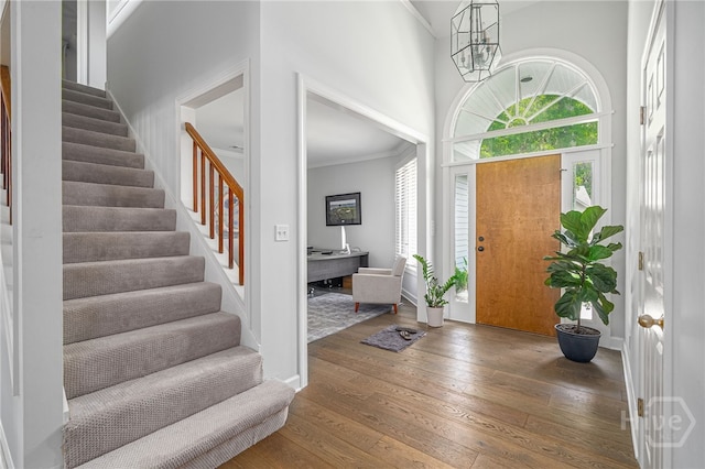 1 Broomsedge Ln, Savannah, GA 31411 - foyer entrance featuring ornamental molding, wood-type flooring, plenty of natural light, stairs, and a high ceiling