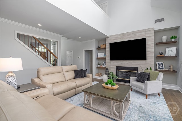1 Broomsedge Ln, Savannah, GA 31411 - living area with ornamental molding, wood finished floors, a premium fireplace, stairway, and built in features