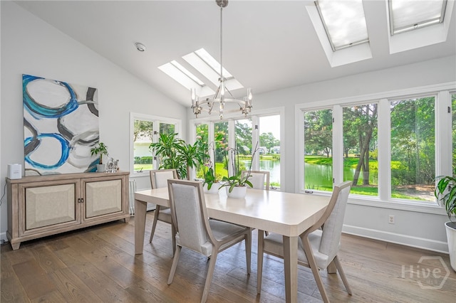 1 Broomsedge Ln, Savannah, GA 31411 - dining area featuring a skylight, vaulted ceiling, healthy amount of natural light, and wood finished floors