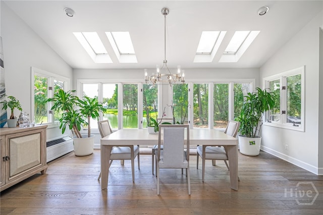 1 Broomsedge Ln, Savannah, GA 31411 - dining area featuring a skylight, vaulted ceiling, a chandelier, and wood finished floors