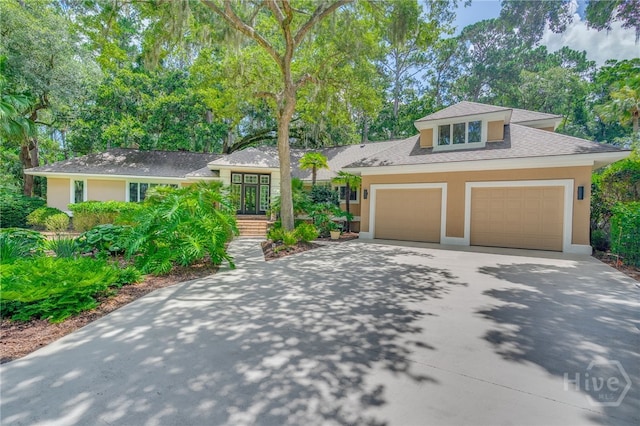 32 Hasleiters Retreat Retreat, Savannah, GA 31411 - view of front of property with driveway, stucco siding, a shingled roof, and a garage