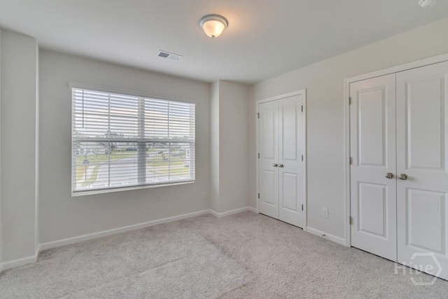 1057 Waybridge Way, Richmond Hill, GA 31324 - unfurnished bedroom with multiple closets and carpet flooring