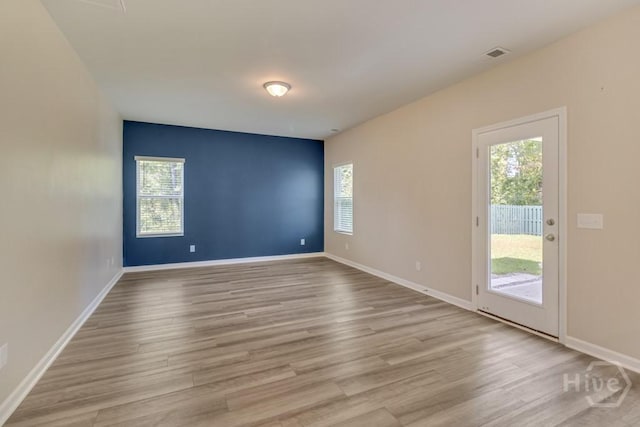1057 Waybridge Way, Richmond Hill, GA 31324 - unfurnished room featuring plenty of natural light and light wood-style flooring