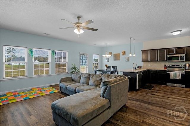 291 Morgan Field Blvd NE, Ludowici, GA 31316 - living room with dark wood-style floors, ceiling fan, a chandelier, and a textured ceiling