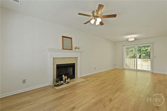 127 Laurel Green Ct, Savannah, GA 31419 - unfurnished living room with light wood-type flooring, a ceiling fan, and a tile fireplace