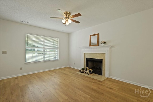 127 Laurel Green Ct, Savannah, GA 31419 - unfurnished living room featuring ceiling fan, light wood-style flooring, and a fireplace