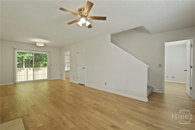 127 Laurel Green Ct, Savannah, GA 31419 - unfurnished living room featuring ceiling fan, stairway, and light wood-style flooring