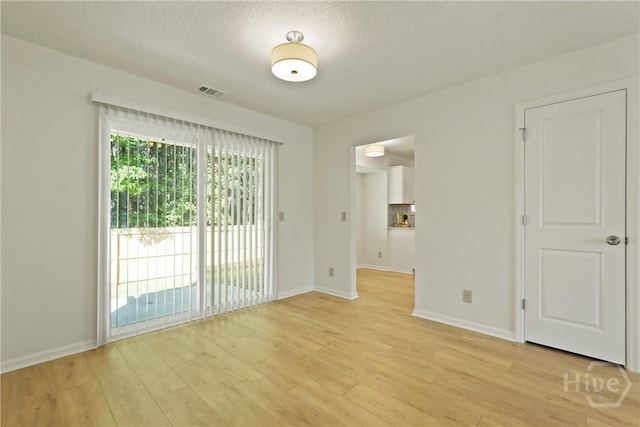 127 Laurel Green Ct, Savannah, GA 31419 - spare room featuring light wood-style flooring and a textured ceiling